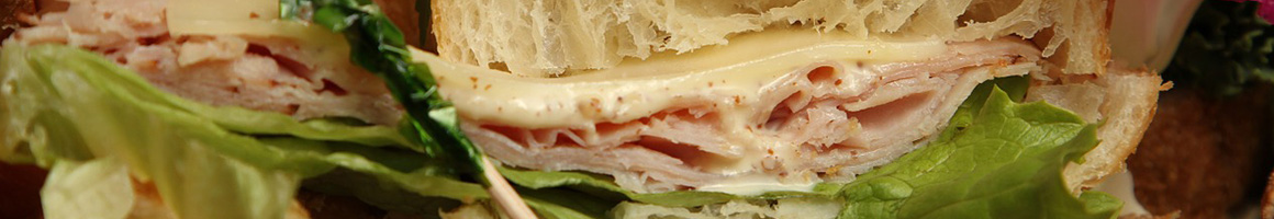 Eating Deli Sandwich at Cousins Subs restaurant in Kenosha, WI.